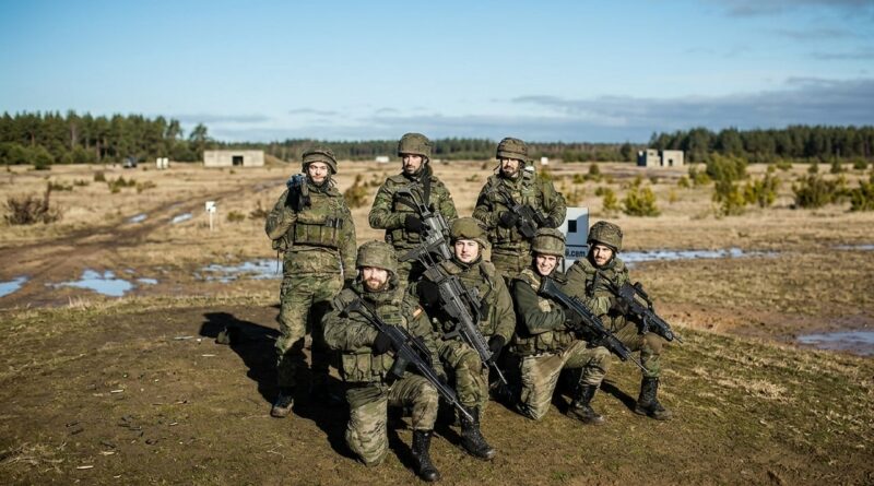 Spanish soldiers assigned to NATO's enhanced Forward Presence Battlegroup in Latvia, pose for a photo during weapons training at Camp Ādaži on 18 February 2022; Photo via: flickr