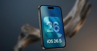 A sleek 3D render of a dark titanium iPhone displaying a glass-morphism style iOS 26.5 logo against a moody, blurred background.